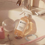 LEAFI Aroma Freesia & Pear luxury room spray 200ml styled on a bathroom vanity with beauty accessories