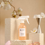 LEAFI Aroma Freesia & Pear luxury room spray 200ml styled with orchid flowers on stone podium