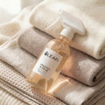 LEAFI Aroma Freesia & Pear luxury room spray 200ml resting on stacked soft neutral towels
