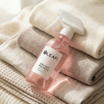 LEAFI Aroma Secret Flower luxury room spray 200ml resting on stacked soft neutral towels