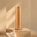 LEAFI Aura 200 Gold on a travertine pedestal in warm afternoon light