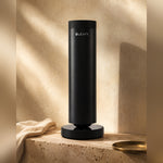 LEAFI Aura 300 Black on a travertine pedestal in warm afternoon light