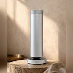 LEAFI Aura 300 Silver on a travertine pedestal in warm afternoon light