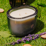 LEAFI Allure Black Oudh & Patchouli candle (400g) surrounded by spices and resins on a dark surface.