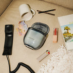 LEAFI Allure Cotton Blossom & Lily candle (400g) styled with accessories on a textured surface.