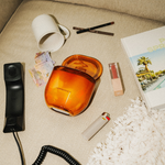 LEAFI Allure Orange & Sandalwood candle (400g) creating ambience in a modern living room.