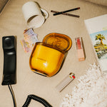 LEAFI Allure Vanilla & Musk candle (400g) styled with accessories on a textured surface.