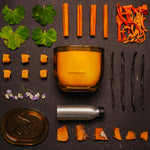 LEAFI Allure Vanilla & Musk candle (400g) with vanilla beans and cinnamon sticks on a dark surface.