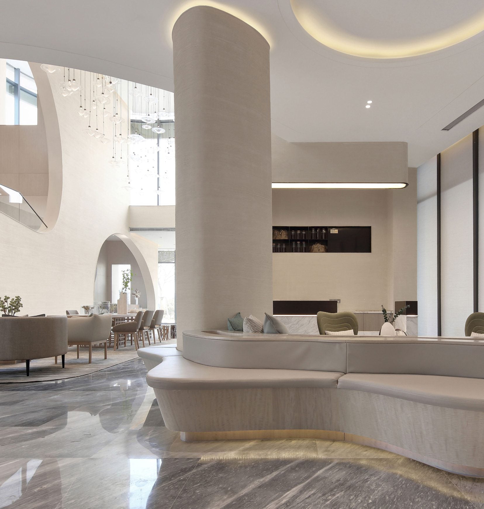 Hotel lobby with curved seating and a sculptural column